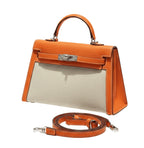Hermès | Kelly Bag In Orange Leather And A Neutral Canvas Material